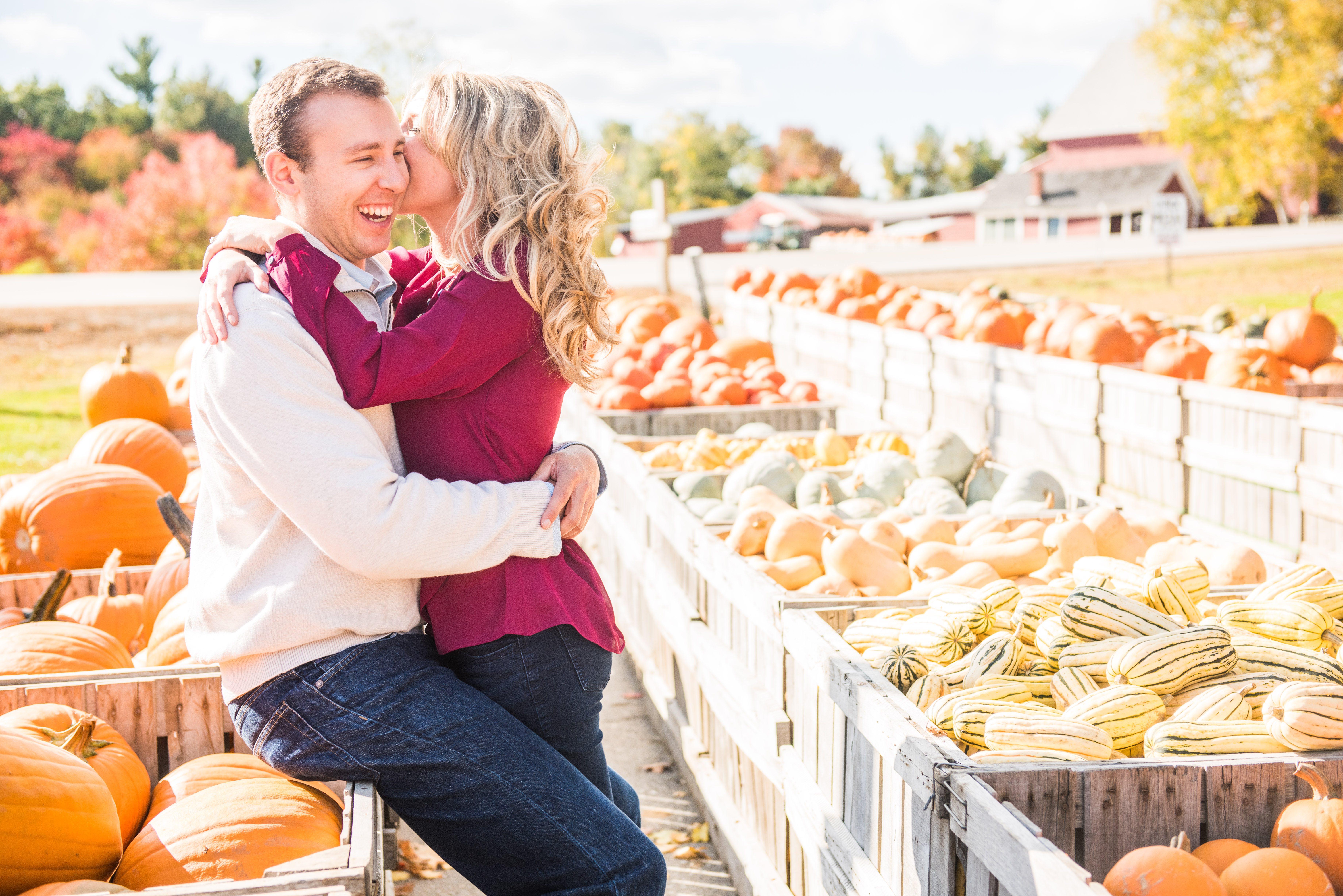 Fall engagement photo of couple at pumpkin patch
