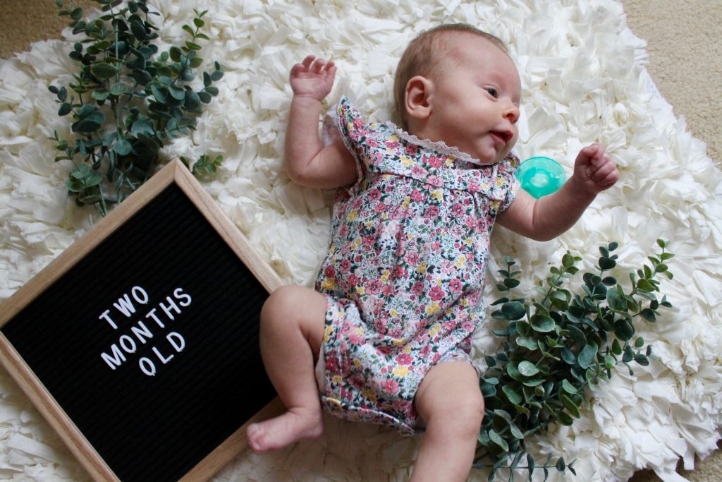 Adorable two month old photo with letter board announcement