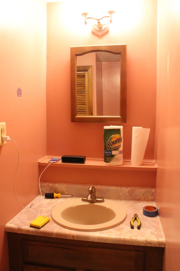 Bathroom vanity and mirror before DIY photo | ourlittlehomestyle.com